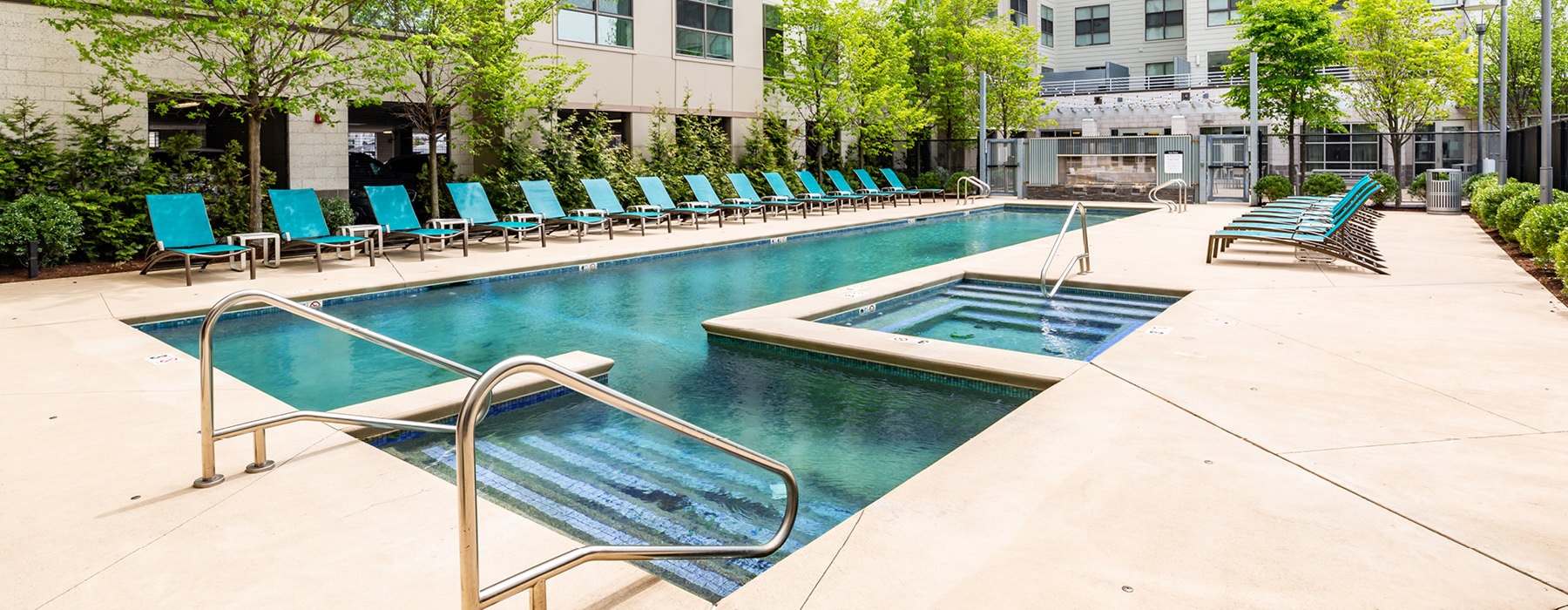 lounge chairs flank outdoor swimming pool