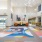 spacious, bright Atrium with colorful area rugs