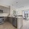 One North of Boston Apartments in Chelsea MA showing peninsula kitchen with living room overlooking Route 1 in background
